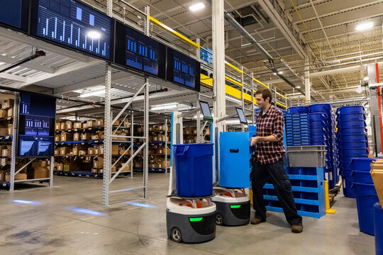 Young worker loads product at  Warehouse   line