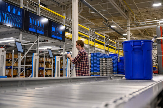 Low Angle image of worker in ecommerce warehouse 