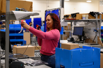 Online shipping warehouse worker scanning bar code