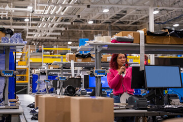 Online shipping warehouse worker with scanner computer