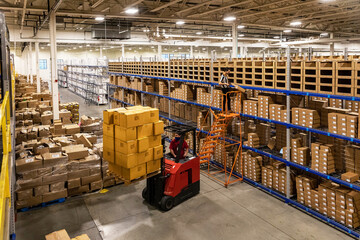Forklift lifting boxes at E-Commerce Warehouse 