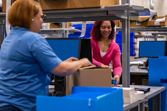 Two workers together at warehouse for Online retail
