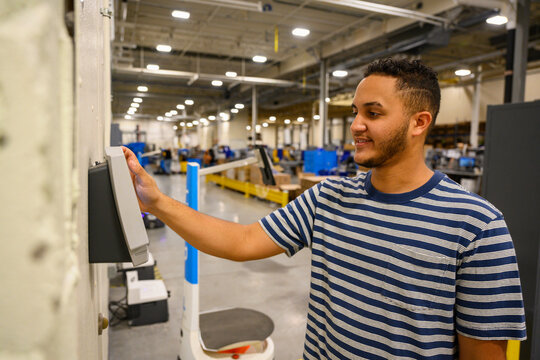 Happy man checking in on time clock 