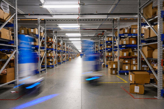 Two Robots glide through Ecommerce  Warehouse 
