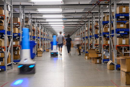Robots and workers at Ecommerce  Warehouse 