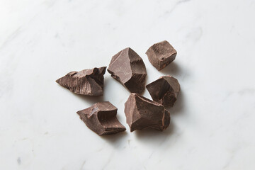 Dark chocolate on white marble background
