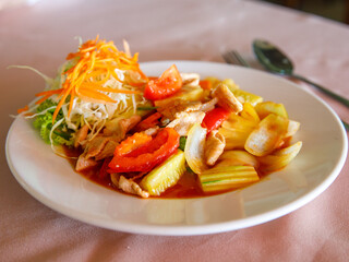 Sweet and sour stir fried pork, thai traditional food with pineapple, cucumber, tomato and other vegetable