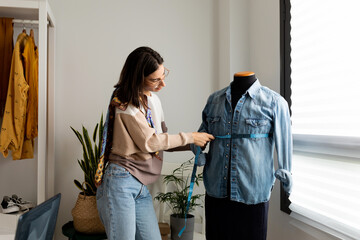 Woman measuring mannequin chest