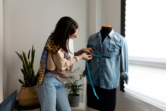 Taking measurements to mannequin with vintage clothes