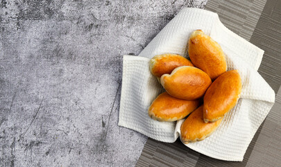 Small pie with green onions and eggs on a dark grey background. Top view, flat lay