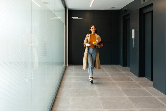 Business woman leaving office at lunch time