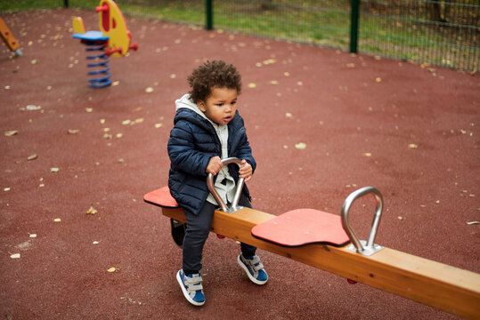 Toddler playing seesaw