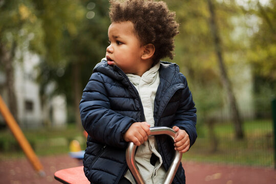 Toddler playing seesaw