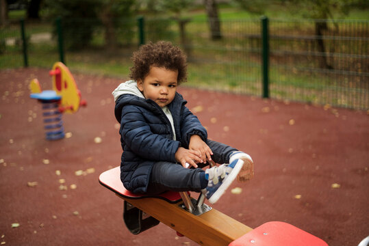 Toddler playing seesaw