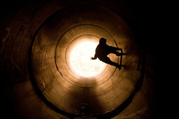 skateboarder skating in a fullpipe
