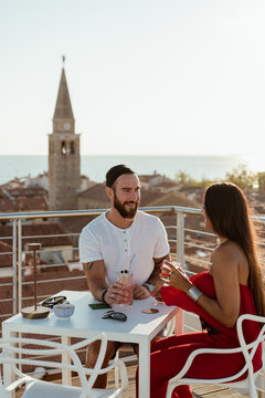 Couple drinking a cocktail at sunset