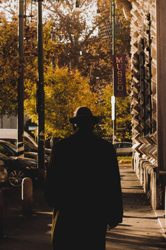 Elegant Man In Hat Walking On Autumn Street 