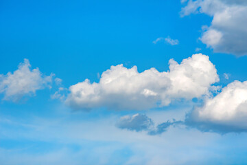 Naklejka na ściany i meble blurred large clouds in the blue sky