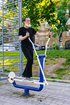 Male retiree working out with sport equipment