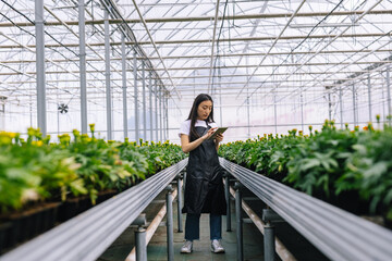 Woman concentrating on work in floral centre