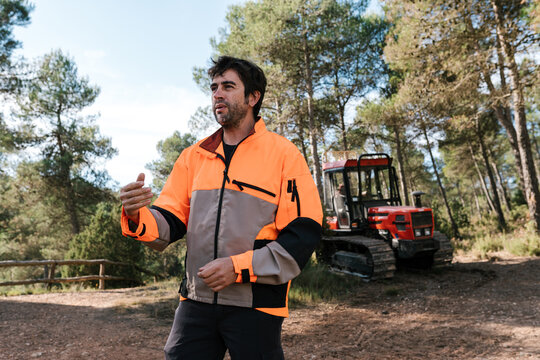 Lumberjack in uniform against crawler