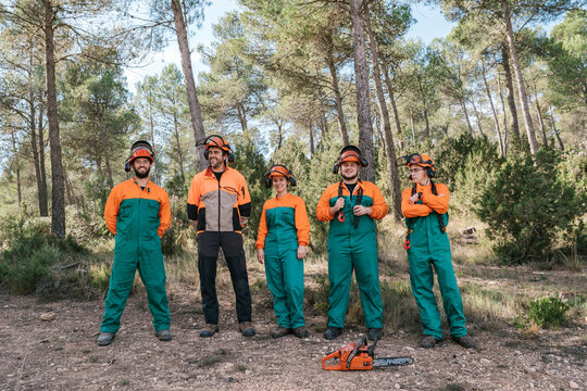 Cheerful lumberjacks in woods