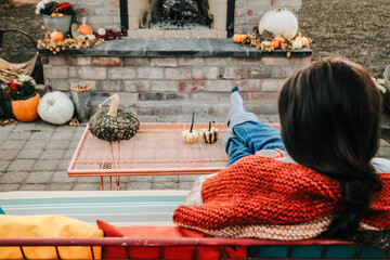 woman relaxing in front of outdoor fireplace