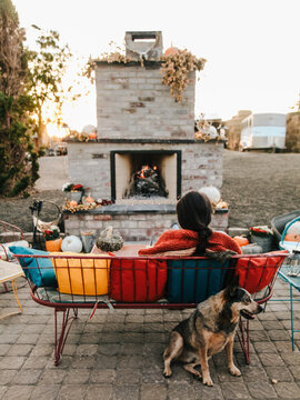 woman and dog sitting on patio