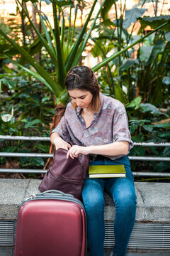 Commuter checking handbag at train station