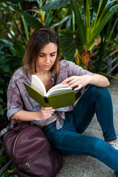 Female commuter reading book