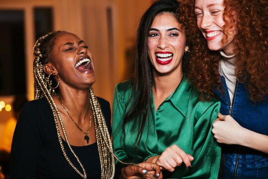 Stylish diverse women laughing at joke