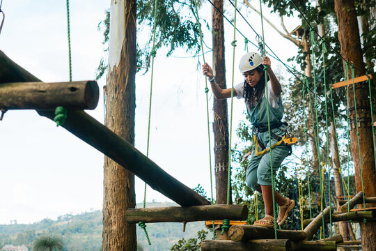 Active woman walking on rope course