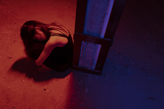 lonely young woman curled up 