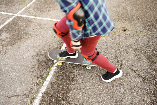 The girl with a skateboard on the playground