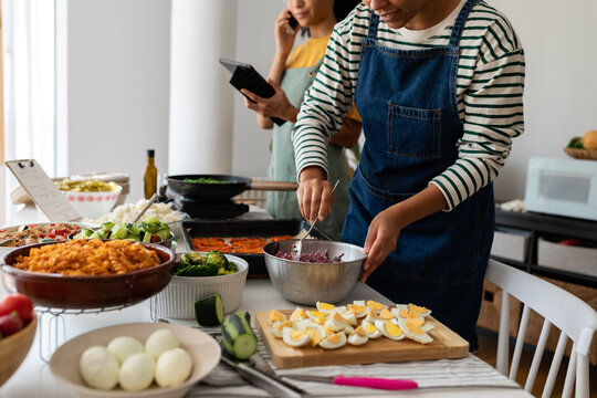 Cooks preparing batch pasta salad