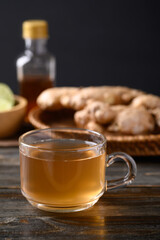 Ginger tea with lime and honey on wooden background, Healthy herbal drink