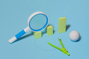 A magnifying glass lying on columns of different height