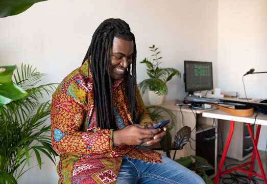 Man Using Phone And Smiling