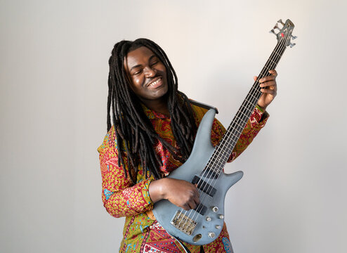 Smiling Guitarist With Dreadlocks At Studio