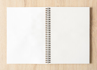Blank spiral bound notepad mockup template with Kraft Paper cover, isolated on wood background.