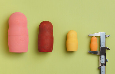 Wooden dolls measured with a calliper