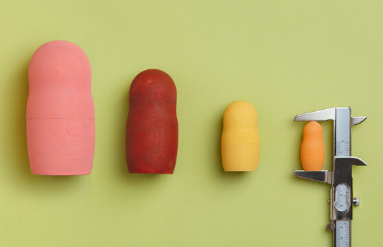 Wooden dolls measured with a calliper