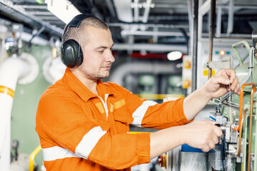 marine mechanic inspects fuel equipment