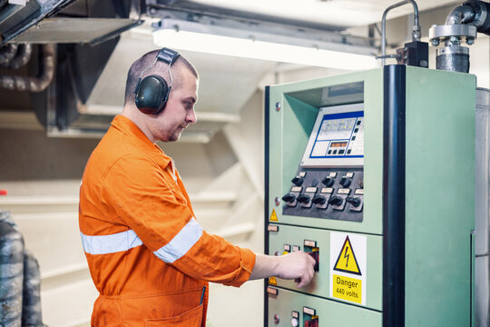 Ship mechanic doing test of main engine