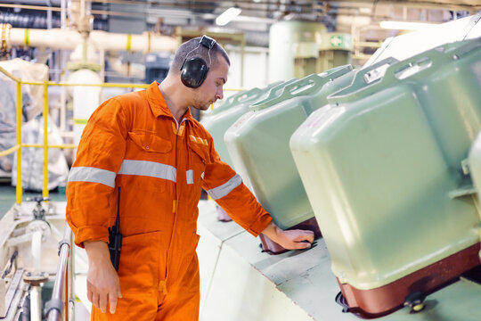 ship engineer inspects main engine