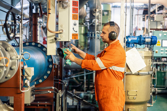 Marine engineer officer checking vessel engines