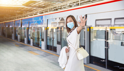 asian woman with medical mask in new normal fashion on transportation