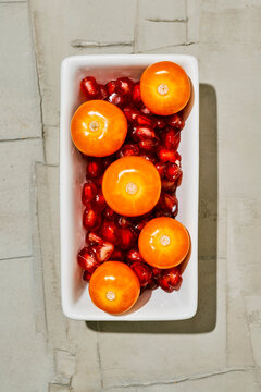 golden berries and pomegranate arils in a plate
