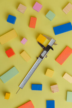 Wooden colourful blocks measured with a calliper