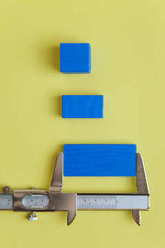 Wooden blocks measured with a caliper